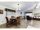 Cozy dining area features a wood table, chairs, and a view of the living room at 17200 W Bell Rd # 1551, Surprise, AZ 85374