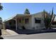 Cozy single-story home featuring a covered carport and desert landscaping at 17200 W Bell Rd # 1551, Surprise, AZ 85374