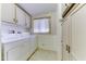 Practical laundry room features white washer, dryer, and storage cabinet at 17200 W Bell Rd # 1551, Surprise, AZ 85374