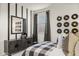 Well-lit bedroom with a striking record display, dark wood dresser, black-out curtains, and a comfortable bed at 17742 W Brown St, Waddell, AZ 85355