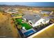 Aerial view of a luxury home featuring a swimming pool, lush landscaping, and a spacious backyard at 17801 W Mountainair St, Surprise, AZ 85388