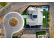 Stunning aerial view of a modern home featuring a private pool, lush landscaping, and a circular driveway at 17801 W Mountainair St, Surprise, AZ 85388