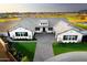 Stunning aerial view of single Gathering home surrounded by lush landscaping and gray driveway pavers at 17801 W Mountainair St, Surprise, AZ 85388