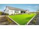 Spacious backyard with lush artificial turf, professional landscaping, and great views of the house at 17801 W Mountainair St, Surprise, AZ 85388
