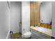 Stylish half-bathroom with modern fixtures, marble countertop, and decorative tile feature wall at 17801 W Mountainair St, Surprise, AZ 85388