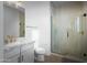 Modern bathroom with a glass-enclosed shower, designer tile, and a vanity with a marble countertop at 17801 W Mountainair St, Surprise, AZ 85388