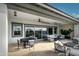 Inviting covered patio featuring ample seating, an outdoor kitchen area, and views of the landscaped yard at 17801 W Mountainair St, Surprise, AZ 85388
