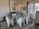 Stylish dining room featuring a glass table, soft textured white chairs and unique lighting fixture at 17801 W Mountainair St, Surprise, AZ 85388