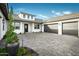Spacious home featuring a three car garage, gray driveway pavers, and desert landscaping at 17801 W Mountainair St, Surprise, AZ 85388