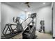 Exercise room with weight-lifting equipment, laminate flooring, and modern fixtures at 17801 W Mountainair St, Surprise, AZ 85388