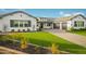 Beautiful single-Gathering home featuring a lush lawn, elegant driveway, and a welcoming front entrance at 17801 W Mountainair St, Surprise, AZ 85388