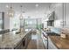 Beautiful open kitchen with stainless steel appliances, granite countertops, and views to the living room at 17801 W Mountainair St, Surprise, AZ 85388