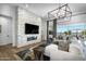 Inviting living room featuring a stone accent wall, modern fireplace, and sliding glass doors to the outside patio at 17801 W Mountainair St, Surprise, AZ 85388