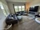 Inviting living room with comfortable sofas, large windows, and fireplace, creating a cozy atmosphere at 17801 W Mountainair St, Surprise, AZ 85388
