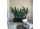 Relaxing outdoor patio featuring neutral color scheme, comfortable seating, and decorative potted plants at 17801 W Mountainair St, Surprise, AZ 85388