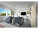 Sitting room with large windows, lounge chairs, and modern fixtures and decor at 17801 W Mountainair St, Surprise, AZ 85388