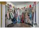 Spacious walk-in closet featuring built-in shelving, hanging rods, and a variety of storage for shoes and clothing at 17801 W Mountainair St, Surprise, AZ 85388
