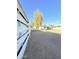 Spacious backyard with wooden fence, mature tree, and potential for landscaping and outdoor activities at 1837 W Virginia Ave, Phoenix, AZ 85007