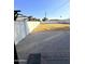 Backyard featuring a brick patio area with a wooden pergola and white block fence with grass yard at 1837 W Virginia Ave, Phoenix, AZ 85007
