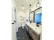 Modern bathroom with dual vanities, geometric tile floors, and black hardware at 1837 W Virginia Ave, Phoenix, AZ 85007