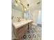 Charming bathroom featuring double vanity with gold fixtures and decorative tile floor at 1837 W Virginia Ave, Phoenix, AZ 85007
