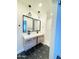 Modern bathroom features double sink vanity with black fixtures and stylish geometric tile floor at 1837 W Virginia Ave, Phoenix, AZ 85007