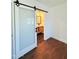 Modern bathroom with sliding barn door, single vanity, geometric tile floors and modern mirror at 1837 W Virginia Ave, Phoenix, AZ 85007