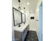 Well-lit bathroom with double sink vanity, modern lighting, and walk-in shower at 1837 W Virginia Ave, Phoenix, AZ 85007