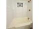 Classic bathtub and shower featuring a white subway tile and decorative tile accent at 1837 W Virginia Ave, Phoenix, AZ 85007