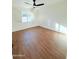 Bright bedroom with hardwood floors, white walls, and a ceiling fan at 1837 W Virginia Ave, Phoenix, AZ 85007