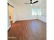 Bedroom with ceiling fan, modern window shutters, and wood-style flooring at 1837 W Virginia Ave, Phoenix, AZ 85007