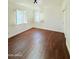 Bright bedroom featuring hardwood floors and windows with classic white shutters at 1837 W Virginia Ave, Phoenix, AZ 85007