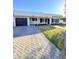 Charming home with manicured lawn, dark shutters, and large driveway for multiple car parking at 1837 W Virginia Ave, Phoenix, AZ 85007