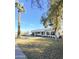 Charming home featuring palm trees, manicured lawn, and a driveway leading to an attached garage at 1837 W Virginia Ave, Phoenix, AZ 85007