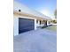 Home featuring a dark garage door and large driveway for multiple car parking at 1837 W Virginia Ave, Phoenix, AZ 85007