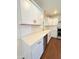 Bright kitchen with white cabinets, stainless steel appliances, quartz countertops, and wood floors at 1837 W Virginia Ave, Phoenix, AZ 85007