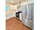 Bright kitchen features stainless steel appliances, white shaker cabinets, and quartz countertops at 1837 W Virginia Ave, Phoenix, AZ 85007