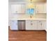 Bright kitchen features white cabinets, stainless steel appliances, quartz countertops, and wood floors at 1837 W Virginia Ave, Phoenix, AZ 85007