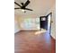 Bright and sunny living room with tile floors, ceiling fan, and an open front door at 1837 W Virginia Ave, Phoenix, AZ 85007