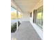 Covered porch with brick floor, white columns and fresh plants at 1837 W Virginia Ave, Phoenix, AZ 85007