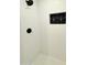 Bright shower featuring white subway tile, black fixtures, and decorative accent at 1837 W Virginia Ave, Phoenix, AZ 85007