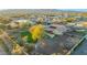 Stunning aerial view of the property showcasing the sprawling lawn, pool, fire pit, and mountain views at 18919 W Verde Ln, Litchfield Park, AZ 85340