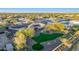 Aerial view of a home, landscaped lawn, backyard pool and patio, and mature trees at 18919 W Verde Ln, Litchfield Park, AZ 85340