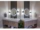 Dual sinks with lighted mirrors, modern faucets, and stylish decor in the bathroom at 18919 W Verde Ln, Litchfield Park, AZ 85340