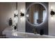 Modern bathroom featuring double sinks, lighted mirrors, and a minimalist design at 18919 W Verde Ln, Litchfield Park, AZ 85340