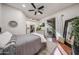 Bright bedroom featuring a ceiling fan, and an en-suite bath with a walk-in closet at 18919 W Verde Ln, Litchfield Park, AZ 85340