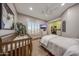 Sun-filled bedroom featuring an en-suite bathroom with walk-in closet and bright window with shutters at 18919 W Verde Ln, Litchfield Park, AZ 85340