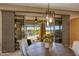 Dining room with a view of the outdoor pool and living area at 18919 W Verde Ln, Litchfield Park, AZ 85340