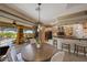 Dining area with round table and access to covered patio and pool at 18919 W Verde Ln, Litchfield Park, AZ 85340
