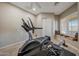 At-home exercise room with treadmill, rowing machine, and comfortable window bench at 18919 W Verde Ln, Litchfield Park, AZ 85340